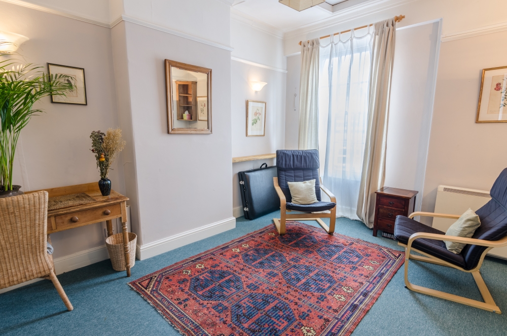 Spacious therapy room with two chairs and a desk at The Practice Rooms in Cotham Hill, Bristol