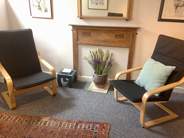 Therapy room with two chairs, mantel piece and dried flowers at The Practice Rooms in Southville, Bristol