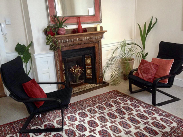 Therapy room with chairs, fireplace and plants at The Practice Rooms in Salisbury